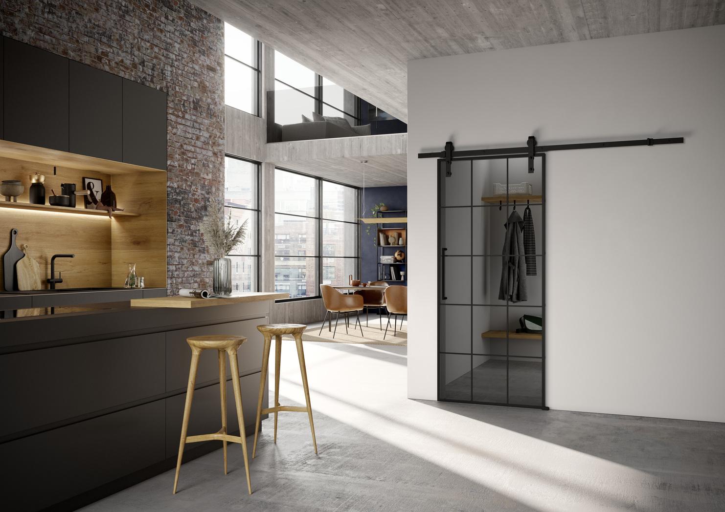 Moderne Loftküche mit Glasschiebetür in schwarzem Stahlrahmen, offener Wohnbereich mit Industriecharme.
